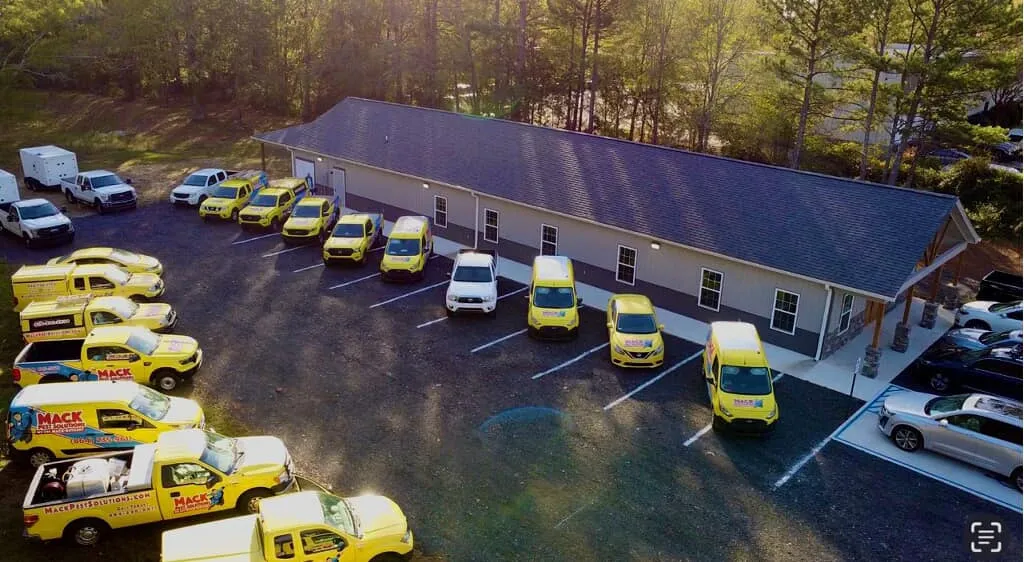 The Mack Pest Solutions yellow fleet outside headquarters